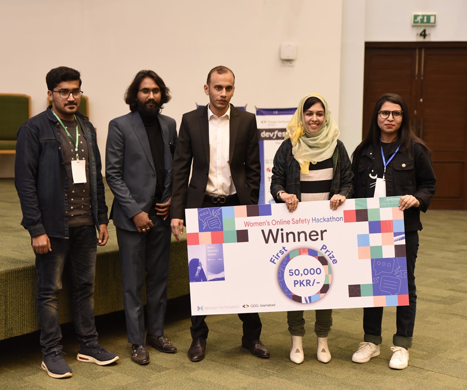 First prize team celebrating with the cheque after the announcement