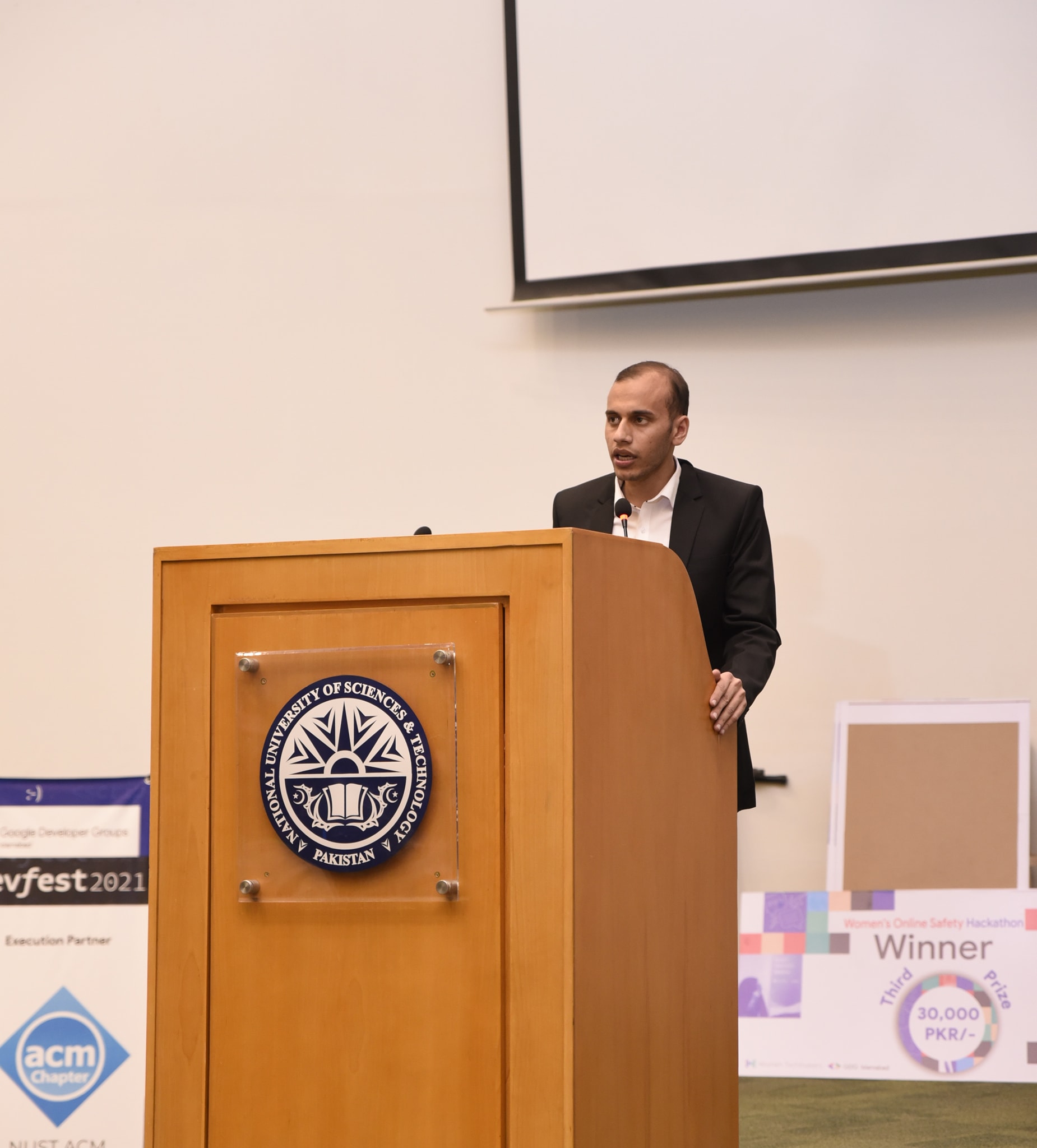 Host announcing the winners from the NUST podium