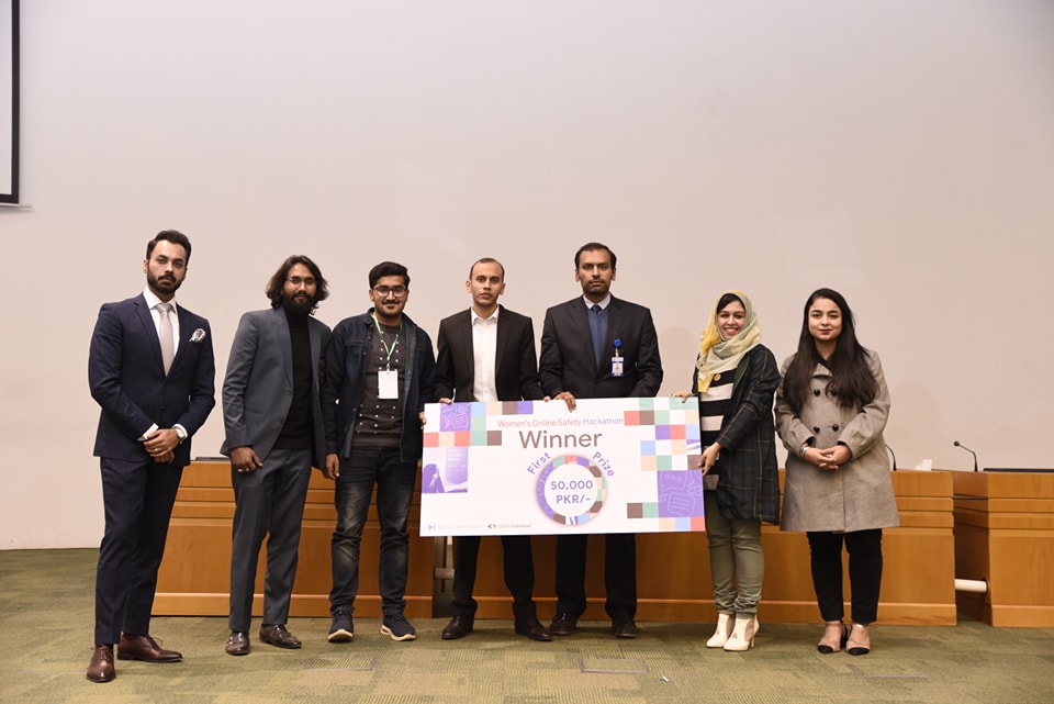 First prize winners receiving the PKR 50,000 cheque on stage